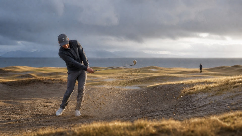 Golfer playing from a coastal bunker while wearing the EnduraLite hat