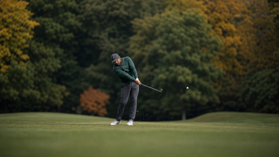 Golfer playing an approach shot from the fairway