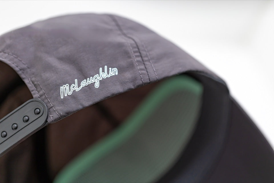 Close view of the McLaughlin wordmark on the rear of the EnduraLite golf hat