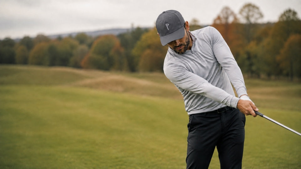 Golfer finishing a shot while wearing the EnduraLite hat