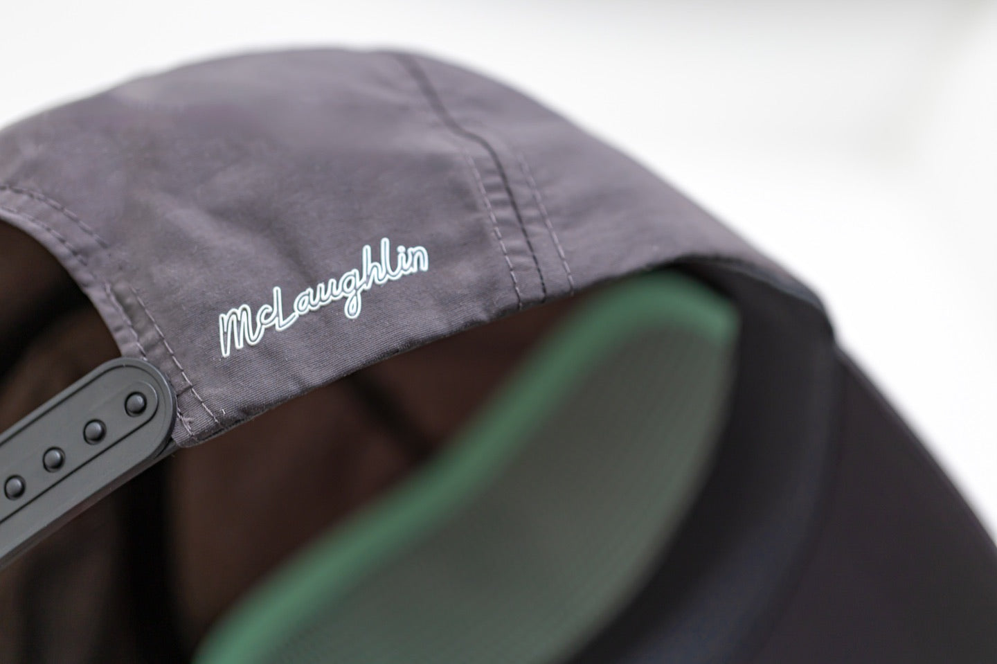McLaughlin signature on the back of the charcoal EnduraLite hat
